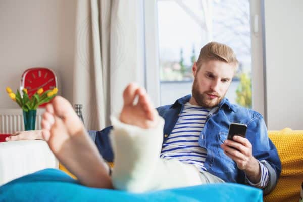 A man in Chattanooga is reading on his phone that his personal injury claim has been denied.