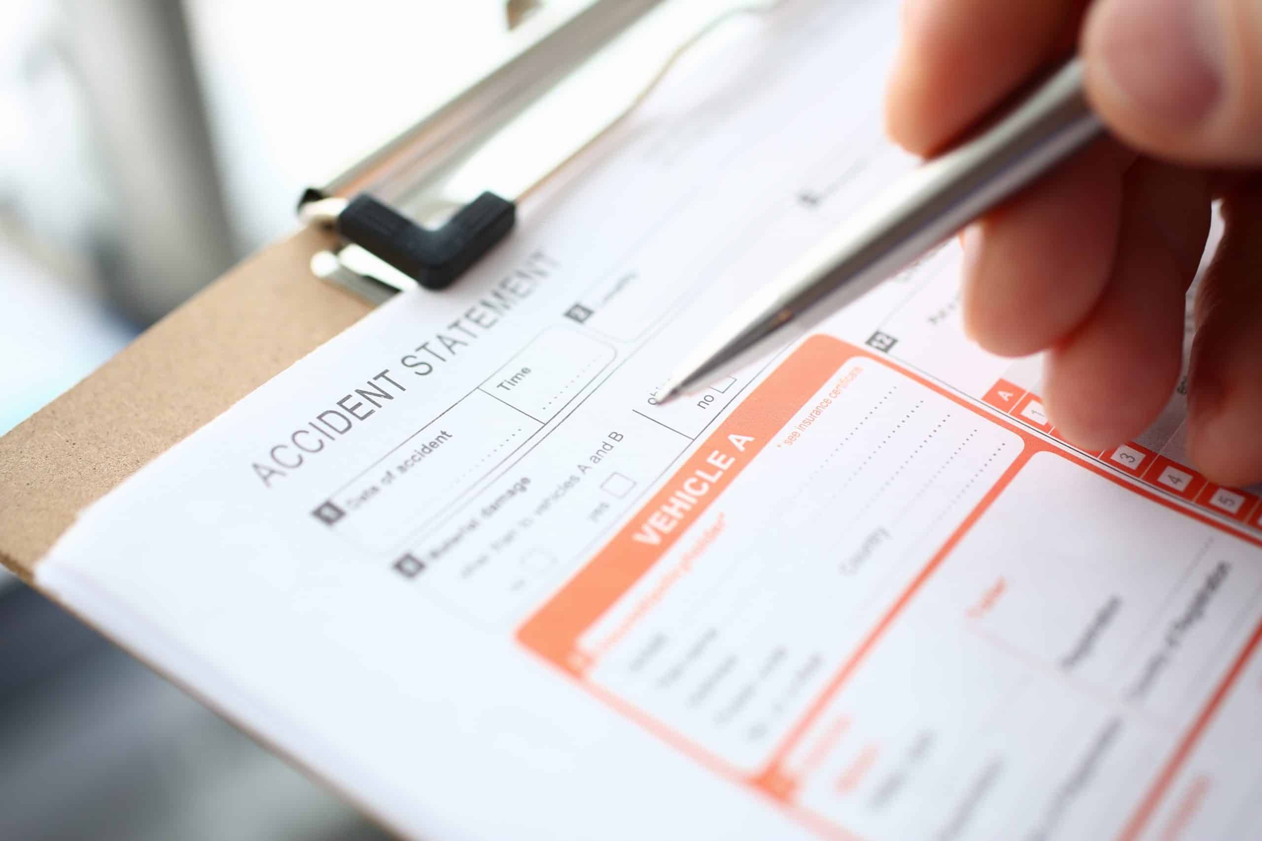 Male insurer hand hold silver pen an accident