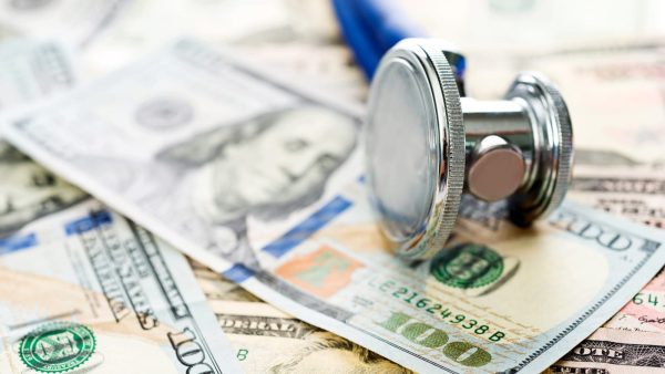 Stethoscope Laying On Top Of $100 Bills Stock Photo