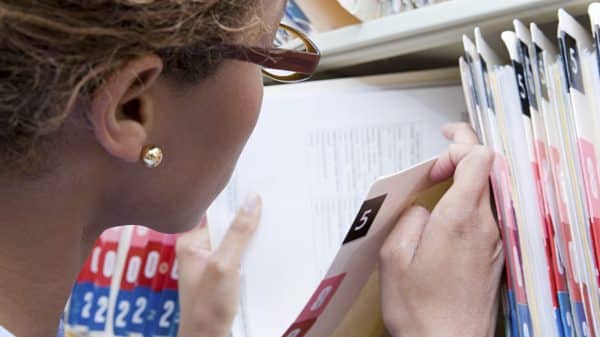 Nurse Searching Through Medical Records Stock Photo