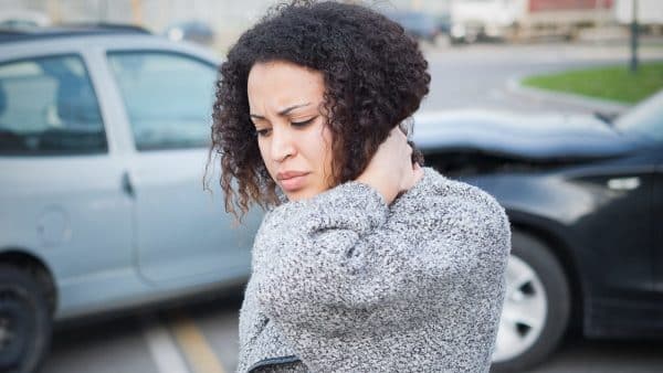 Young Woman Experiencing Neck Pain After A Car Accident Stock Photo