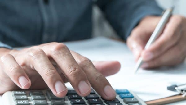Man Using A Calculator Stock Photo
