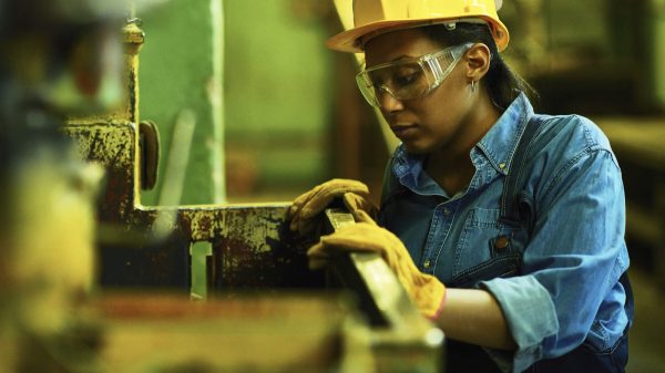 Female Worker In Hard Hat Stock Photo