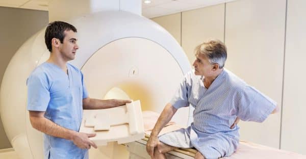 Injured Man Receiving Full Body X-ray Stock Photo