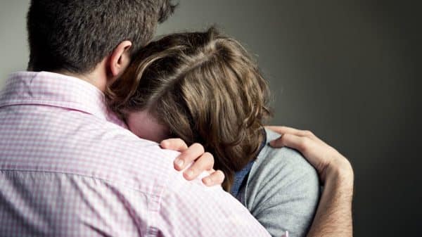 Husband Consoling Wife Stock Photo