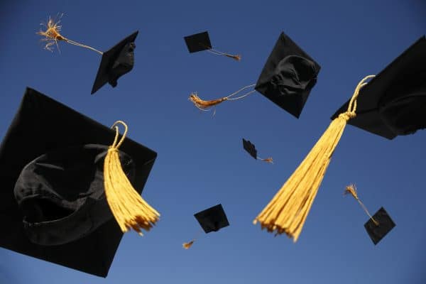 Graduation caps tossed in the air.